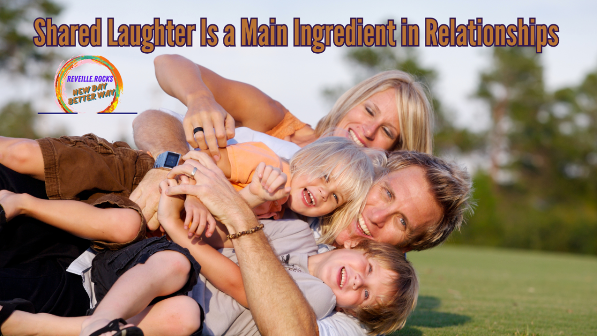 Family rolling and laughing in the grass